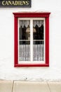 Canadian Hangout with red trimmed window sill and window panes