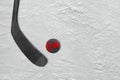 Canadian hockey stick and puck on the ice hockey rink