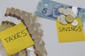 Canadian Money with a note saying savings and taxes Royalty Free Stock Photo