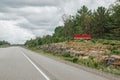 Canadian Ontario touristic destination place landmark. Red word sign Muskoka on empty road in Canada. Summer adventure trip on