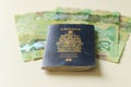 Canadian passport laying on top of twenty dollar bills. Concept of immigrating or emigrating, or travelling with a canadian Royalty Free Stock Photo