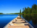 Canadian rabaska canoe resting by the calm water in beautiful Wapizagonke lake. Mauricie National Park, Quebec Canada