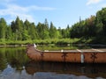 Canadian rabaska canoe resting by the calm water in beautiful Wapizagonke lake. Mauricie National Park, Quebec Canada