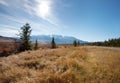 Sun flare above rocky mountains