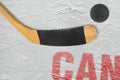 Canadian stick and puck on the ice