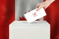 Canadian Vote concept. Voter hand holding ballot paper for election vote on polling station Royalty Free Stock Photo