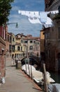 Vacant canal alley with clotheslines Venice, Italy