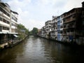 Canal along homes with railway crossing river in bangkok thailand