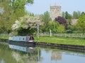 Canal barge moored by a church.