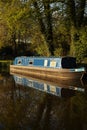 Canal barge narrow boat in water surrounded by trees