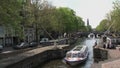 Canal boat in Amsterdam with the westertoren at the background