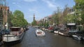 Canal boat in Amsterdam with the westertoren at the background