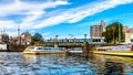 Canal Boat at the Stationsplein at Central Station in Amsterdam in the Netherlands. Royalty Free Stock Photo