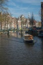 A canal boat making its way down Amsterdam canal