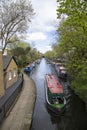 A canal boat moves through Westminster near London, England in the area called Little Venice