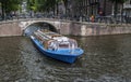 Canal boat showing tourists around Amsterdam