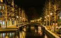Canal bridge in the center of Alphen aan den Rijn, The netherlands, decorated trees with lights, Dutch city Architecture
