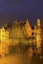 A canal in Bruges with the famous Belfry in Belgium Royalty Free Stock Photo