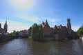 Canal in Bruges and famous Belfry tower on the background in a beautiful spring day Royalty Free Stock Photo