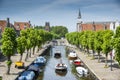 Canal crossing the historic center of Sloten lined with green trees Royalty Free Stock Photo