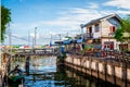 A canal drains water into the sea where houses on both sides are mooring boats for local fishermen at Ban Na Kluea, Pattaya