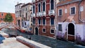 Canal with empty venetian gondola in Venice, Italy