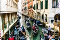 Canal with gondolas in Venice, Italy. Architecture, landmarks and tourists in Venice