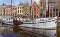 Canal with historic white sailing ship in Groningen