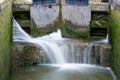 Canal lock cill with water spilling through gate