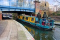 Canal narrow boat/barge going under a bridge