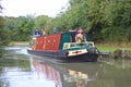 A canal narrowboat cruising along canal