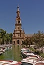 Canal and north wing and tower of Plaza de Espana on a sunny day in Sevilla, Spain.