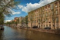 Canal with old brick buildings and boats in Amsterdam Royalty Free Stock Photo