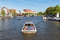 Canal with recreating people in a cruise ship in Amsterdam Royalty Free Stock Photo