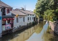 Canal with restaurant and houses and trees, Suzhou, China