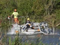 A canal and river trust floating barge used for brush clearing