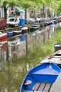 Canal scene with boats houses amsterdam holland Royalty Free Stock Photo