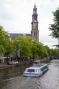 Canal scene with tourist boat westekerk amsterdam