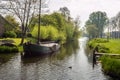 Canal with ship in a small Dutch village Royalty Free Stock Photo