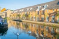 Canal-side apartments reflected in calm water in morning light in Bow Wharf area Hertford Union Canal of London Royalty Free Stock Photo