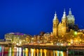 Canal and St Nicholas Church in Amsterdam at twilight, Netherlands. Famous Amsterdam landmark near Central Station. Royalty Free Stock Photo