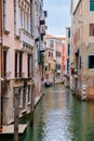 Canal surrounded by old palaces in Venice