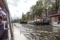 Canal tour boat giving tourist rides. Urban landscape and historic building