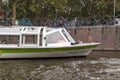 Canal tour boat giving tourist rides. Urban landscape and historic building