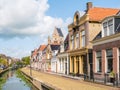 Canal and tower of church in old town of Bolsward, Friesland, Ne