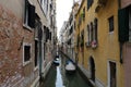 Canal in Venice with docked gondola and boats,