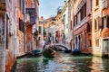 Canal in Venice, Italy with gondolier rowing gondola