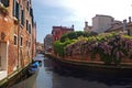 Canal in Venice. Spring in Italy. Boat and flowers, houses above the water