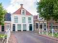 Canal with waterfront house and bridge in old town of Dokkum, Fr