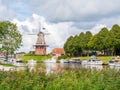 Canal and windmill on fortifications of fortified town of Dokkum, Friesland, Netherlands Royalty Free Stock Photo